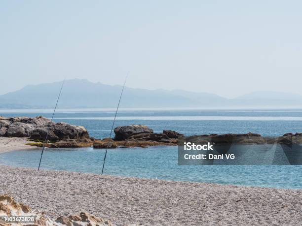 Fishing Rods On The Shore Of The Beach In Sunny Day By The Sea Fishing Relax And Vacation Concept Stock Photo - Download Image Now