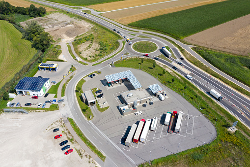 Aerial view of truck stop, gas station, traffic circle in Germany.