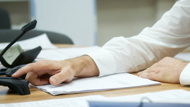 istock A man in a white shirt presses the video camera and microphone button during a video chat or online conference. Without a face. Selective focusing 1403673910