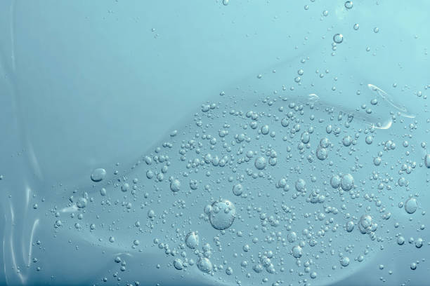 istock Close up macro Aloe vera gel cosmetic texture blue background with bubbles. 1403675312