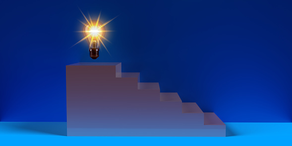 Abstract ladder concept for achievement and success in business or education. Glowing light bulb on top of the ladder in front of blue wall with copy space.