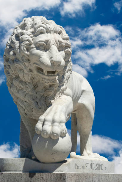 Bridge of Lions St. Augustine, Florida Close view of lion statue at the bridge of lions, St. Augustine, Florida, blue sky with clouds in background, statue front view from slightly below, no people, sunny day bridge of lions stock pictures, royalty-free photos & images