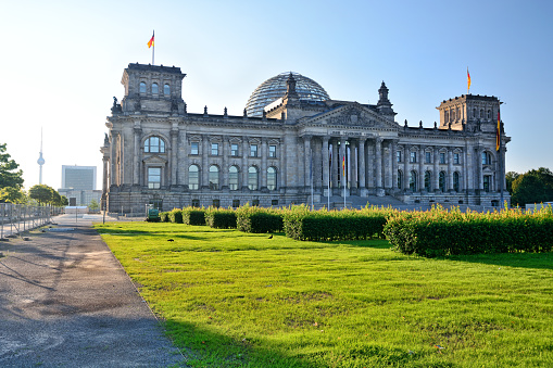 The Reichstag building seen from the former Königsplatz at sunrise in Berlin, Germany.