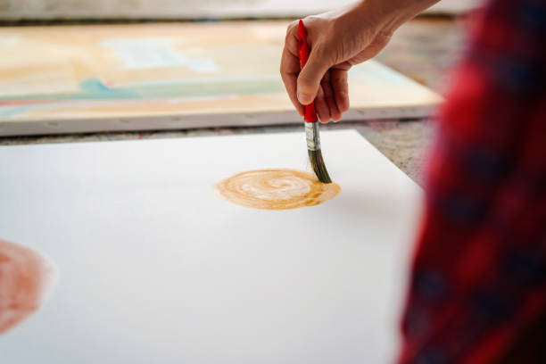 istock Male hand painting on canvas 1403680133