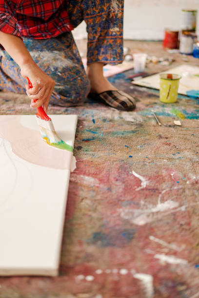 istock Unrecognizable male person painting canvas 1403680203