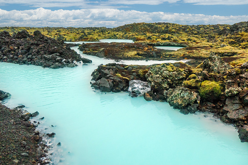 The amazing volcanic landscape near the Blue Lagoon in south-west Iceland. Gorgeous blue water makes its way between moss-covered basalt.