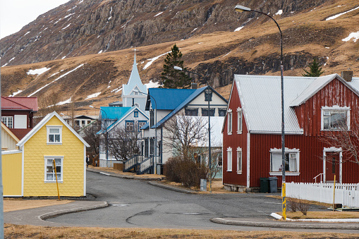 The beautiful and colourful village of Seydisfjördur on the northeast coast of Iceland. The nucleus of the town as we see it now was built by Norwegian fishermen starting from 1848. One can clearly recognise the Scandinavian style in the many wood buildings still existing in the village. One of the landmarks of Seyðisfjörður is The Blue Church / Bláakirkja.