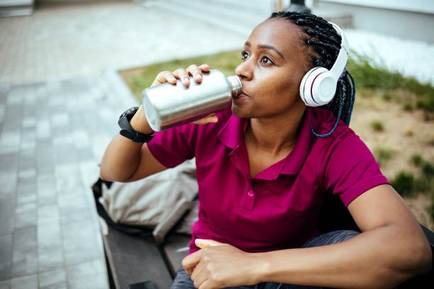 istock Woman sitting on bench after exercise in park 1403681421