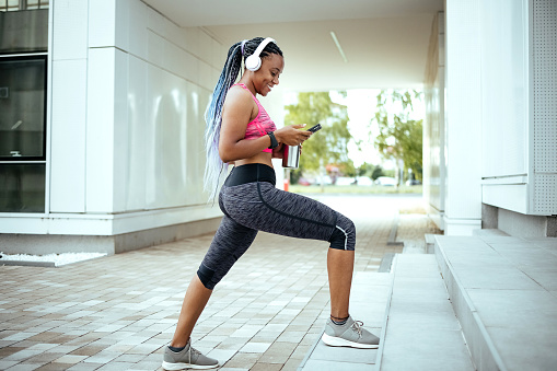 Young woman listening to music during a workout