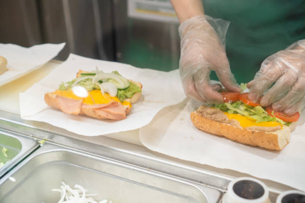 istock Close up of Hand Preparing Sandwich 1403683035