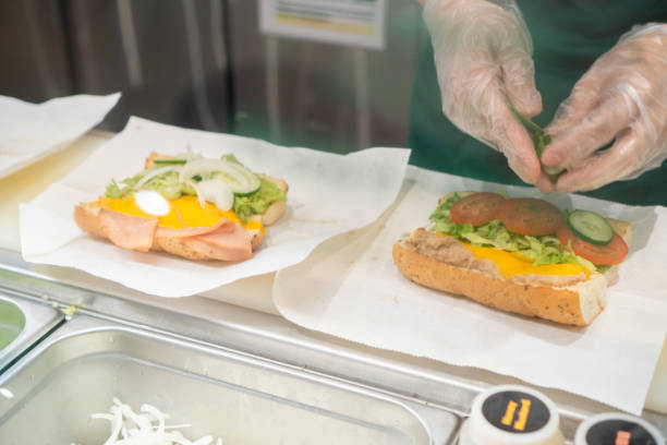 istock Close up of Hand Preparing Sandwich 1403683058