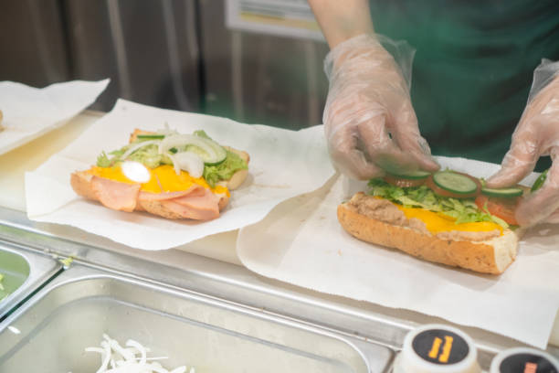 istock Close up of Hand Preparing Sandwich 1403683082