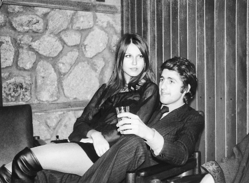 Happy young couple at party in 1970.