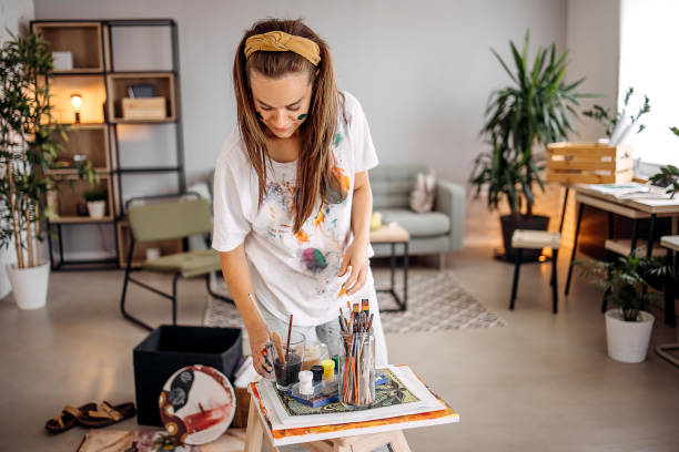 istock Woman stands and paints 1403683990