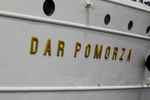Gdynia, Poland - May 27, 2022: Dar Pomorza , lettering on the side of the ship. The name of a three-masted training sailing ship, donated by the Pomeranian society in 1929 for the Maritime School