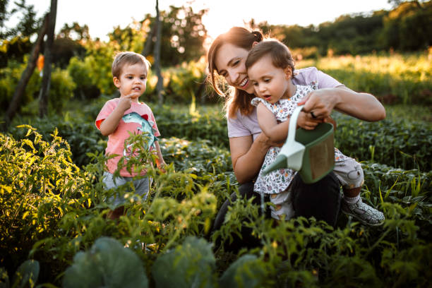 Children working in garden with mother