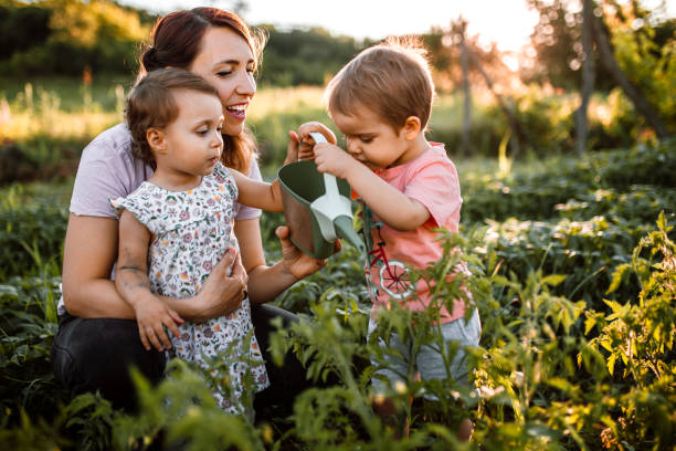 istock Children working in garden with mother 1403684478