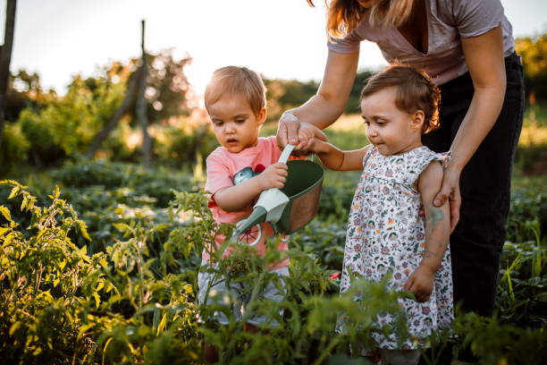 istock Children working in garden with mother 1403684619