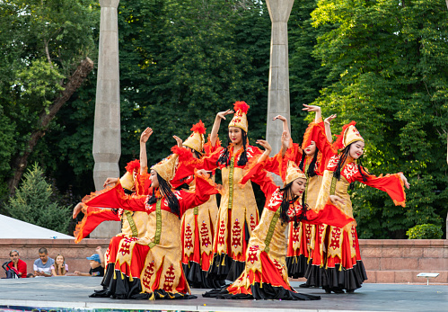 Bishkek, Kyrgyzstan - June 18, 2022: Young girls dancing Kyrgyz dance