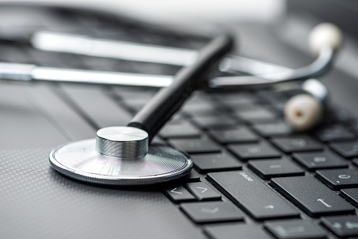 Stethoscope on laptop keyboard. Healthcare And Medicine Concepts