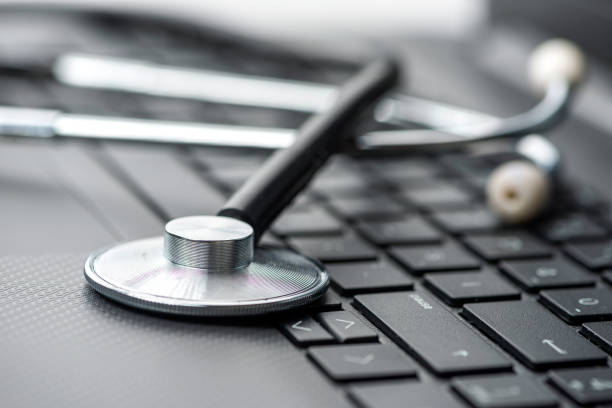 stethoscope on laptop keyboard. healthcare and medicine concepts - computer bug stethoscope computer problems imagens e fotografias de stock