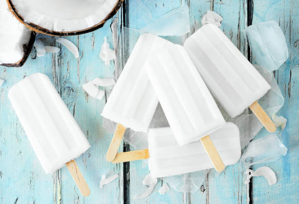 istock Coconut popsicles in a cluster over a blue wood background 1403688936