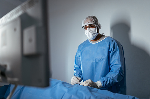 Surgeon doctor looking at monitor during surgery