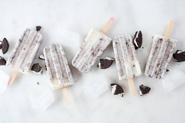 istock Cookies and cream ice pops over a marble background 1403689371