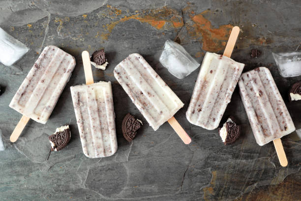 istock Cookies and cream popsicles over a dark background 1403690014