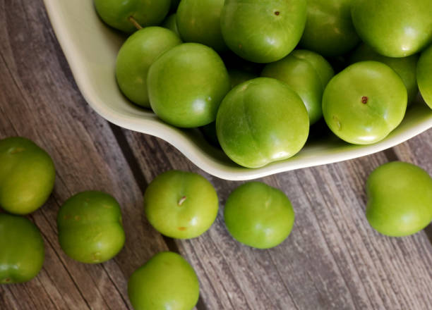 istock green plums on the wooden table 1403691184