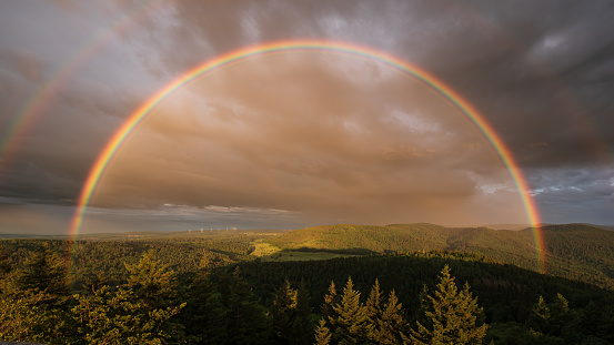 Dreamlike rainbow after a summer thunderstorm shortly before the sun goes down