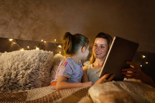 istock Reading Before Bed - Bedtime Story Mother and Daughter 1403692918