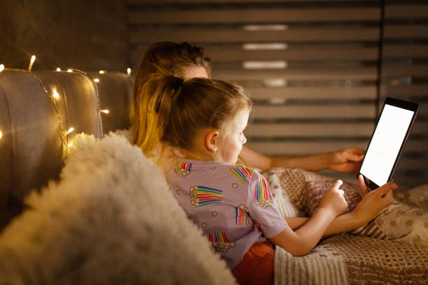 istock Reading Before Bed - Bedtime Story Mother and Daughter 1403692926