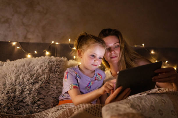 istock Reading Before Bed - Bedtime Story Mother and Daughter 1403692931