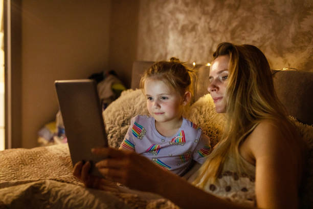 istock Reading Before Bed - Bedtime Story Mother and Daughter 1403692946