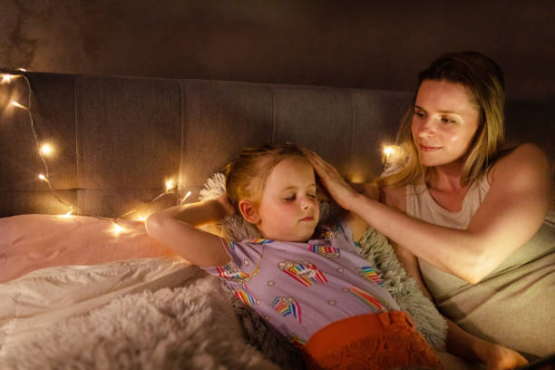 istock Reading Before Bed - Bedtime Story Mother and Daughter 1403692962