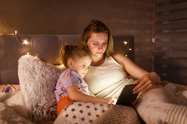 istock Reading Before Bed - Bedtime Story Mother and Daughter 1403692971