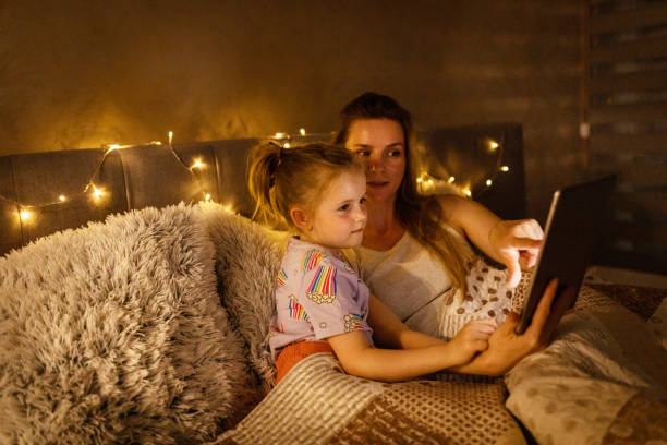 istock Reading Before Bed - Bedtime Story Mother and Daughter 1403692976