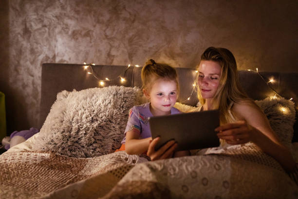 istock Reading Before Bed - Bedtime Story Mother and Daughter 1403692982