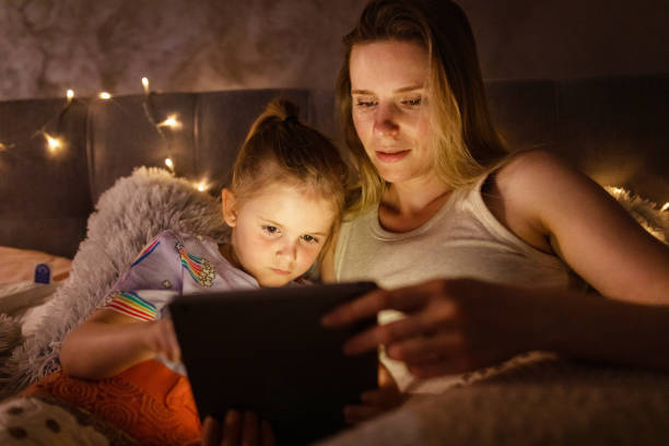 istock Reading Before Bed - Bedtime Story Mother and Daughter 1403693059