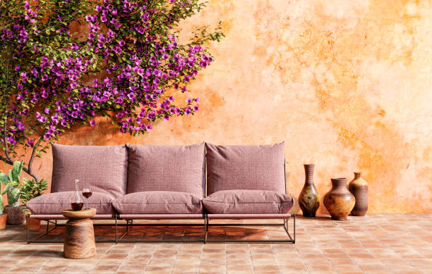 Sunny Mediterranean-style terrace with sofa, small wine table and beautiful bougainvillea. 3D render. stock photo