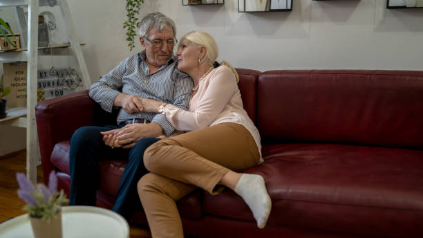 istock senior couple relaxing on the couch at home 1403694016