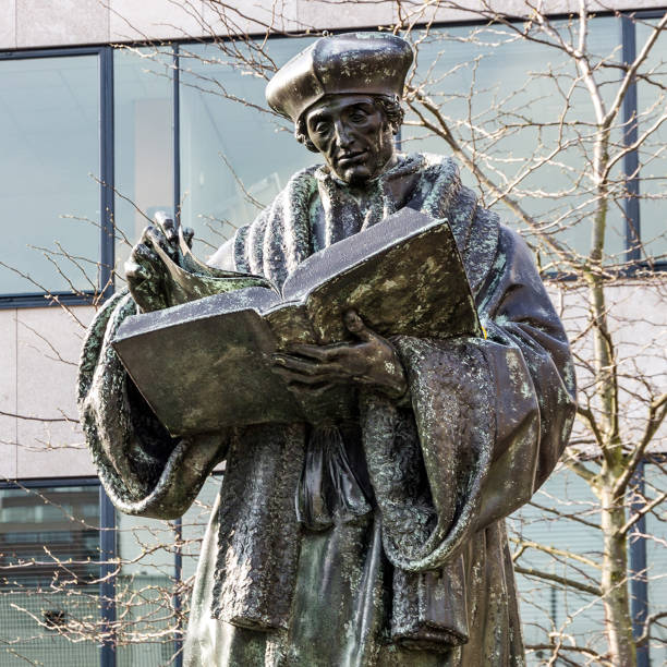 Rotterdam, Netherlands - May 30, 2022: Monument to Erasmus of Rotterdam, Netherlands (Desiderius Erasmus Roterodamus). The statue of Desiderius Erasmus is the oldest statue in the Netherlands. It stands in Grote Kerkplein, just a stone s throw from the Laurenskerk. Desiderius Erasmus was a famous Renaissance humanist, theologian and philosopher who was born in Rotterdam around 1468.