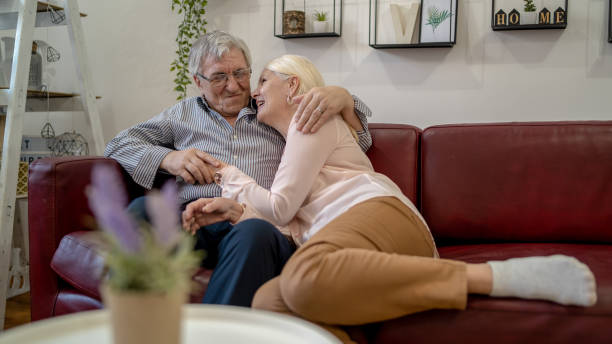 istock senior couple relaxing on the couch at home 1403694683