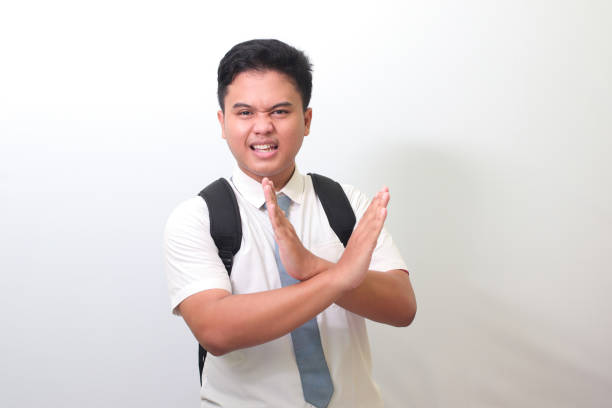 istock senior high school student showing X sign of hands, refusing an invitation from someone 1403695229