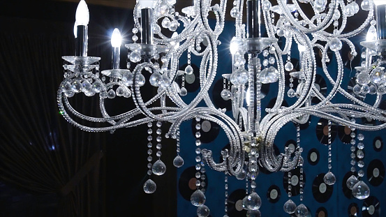 Vintage chandelier. Clip. Close up on crystal of contemporary chandelier, is a branched ornamental light fixture designed to be mounted on ceilings or walls.