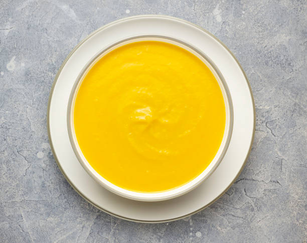 istock Top view vegan pumpkin soup in the white bowl on concrete surface 1403703608