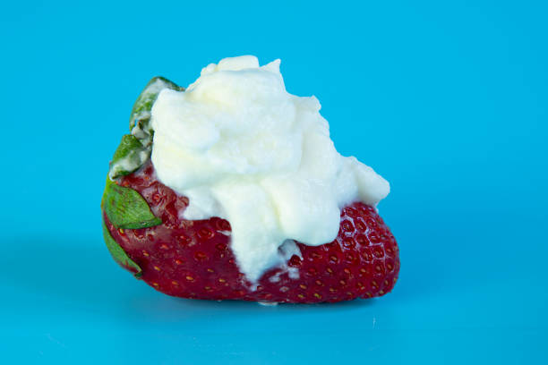 istock large strawberries with cream on a blue background 1403704187