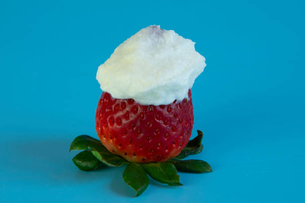 istock large strawberries with cream on a blue background 1403704206