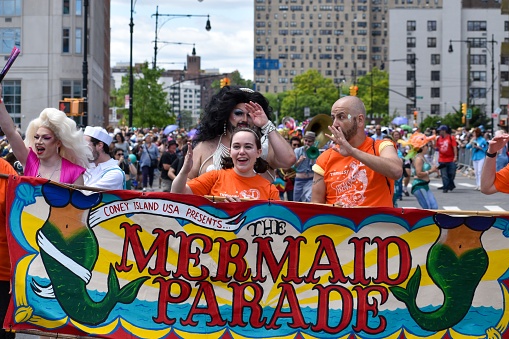 Participants holding the Mermaid Parade banner at the 2022 Mermaid Parade at Coney Island on June 18, 2022 in the Brooklyn borough of New York City.